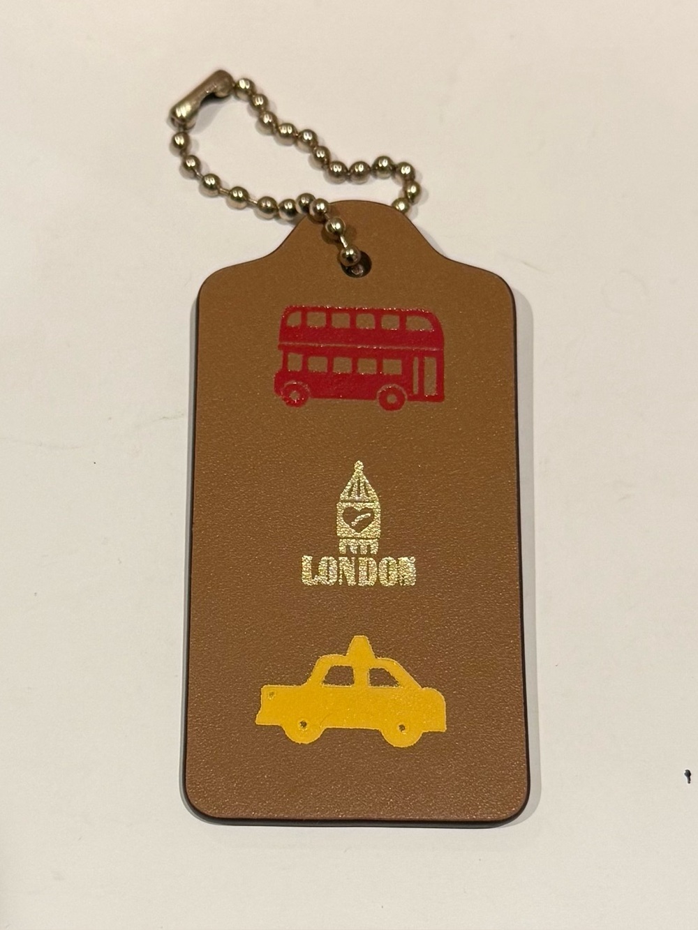 Coach London icons large hangtag Tan